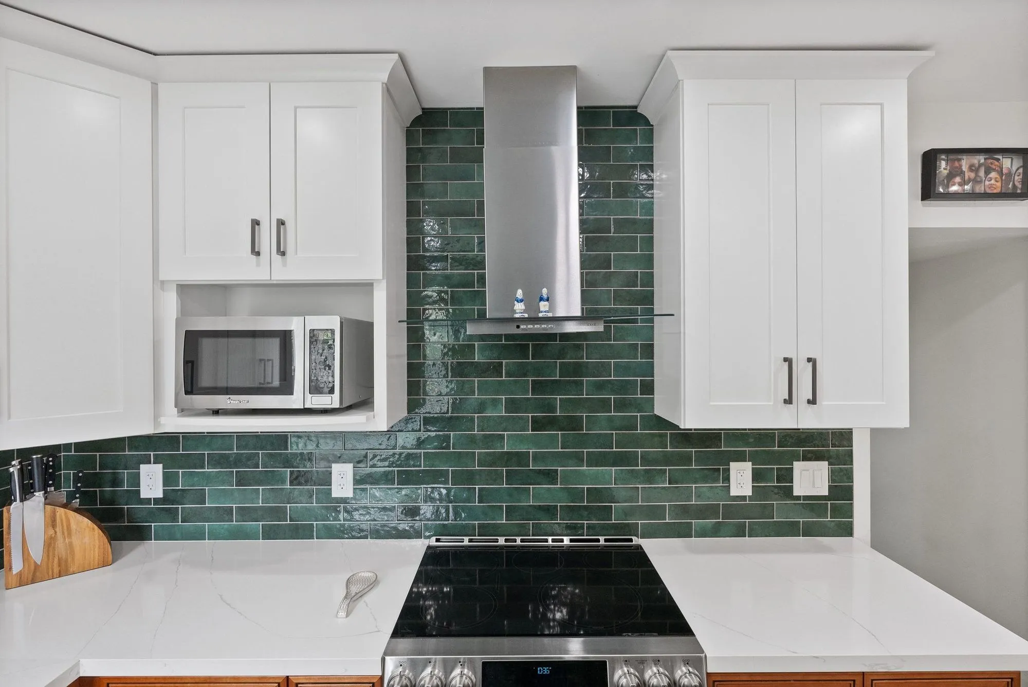 Cooktop and built-in microwave set into the run beneath the stainless hood
