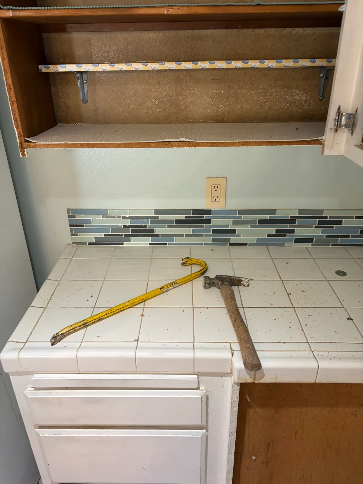 Before — demo underway, hammer and pry bar