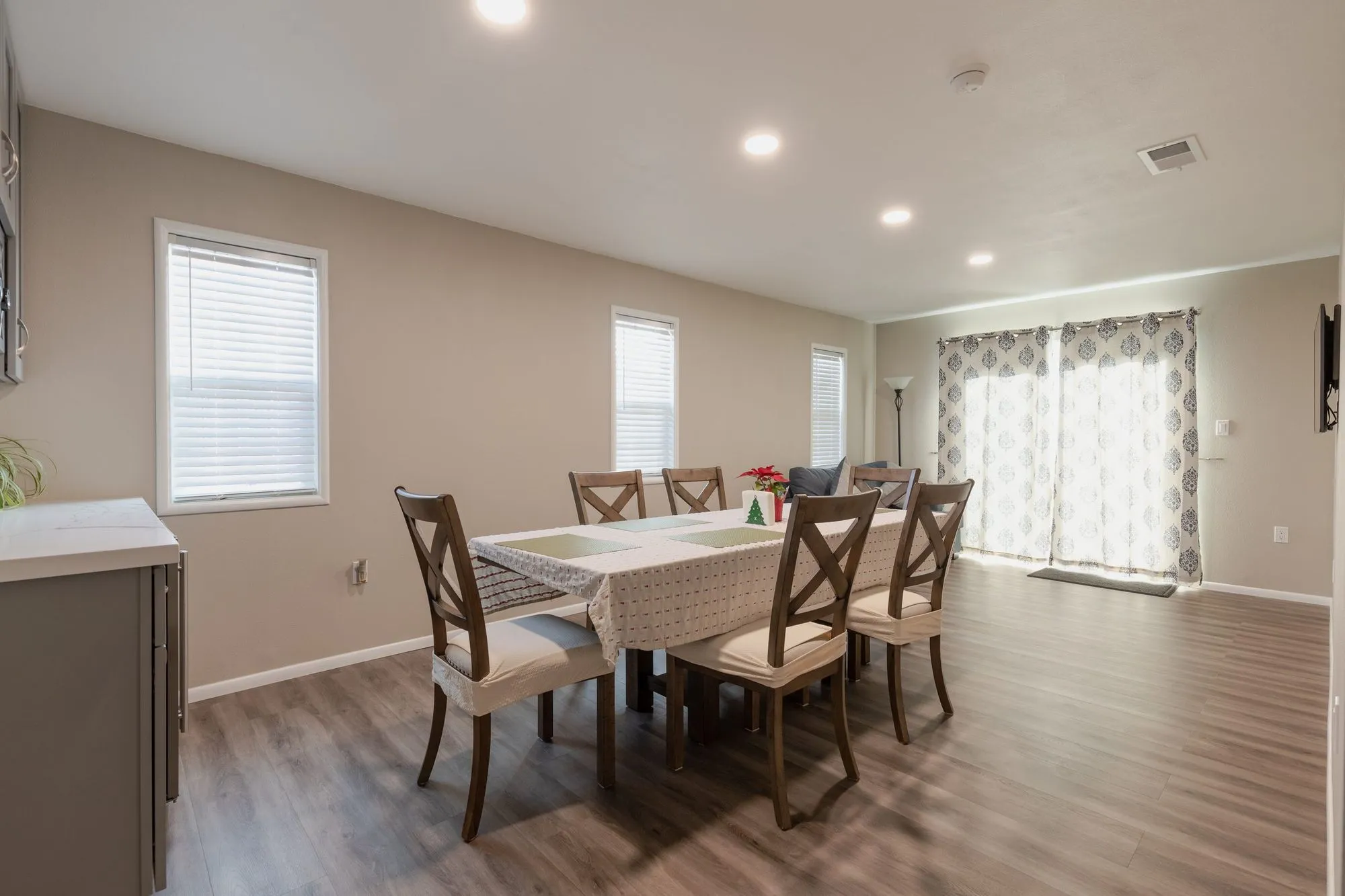 Dining area open to the living space with light plank flooring throughout