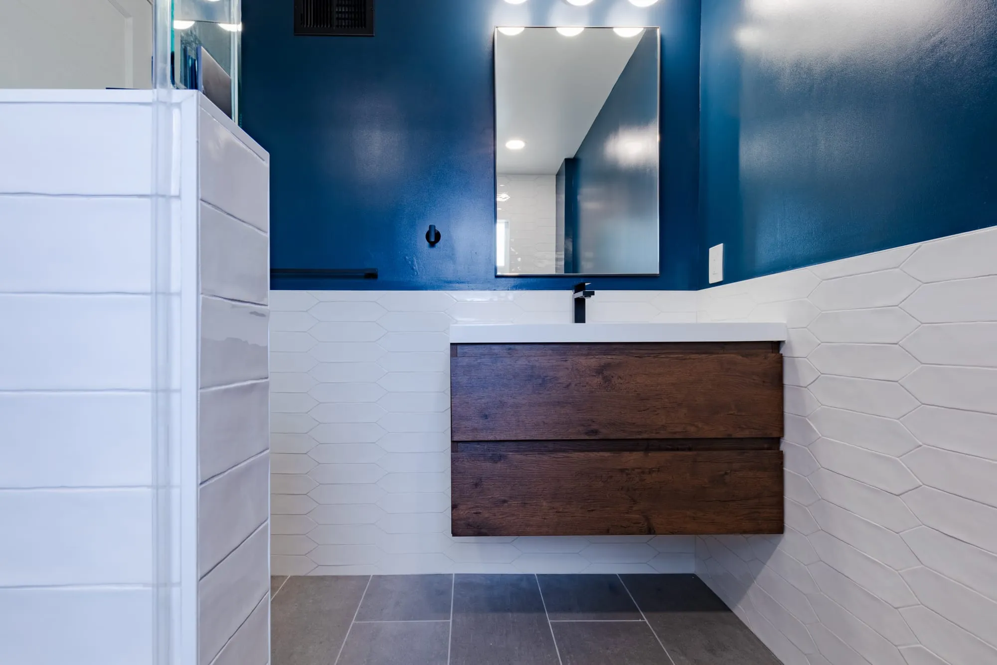 Floating walnut vanity with an integrated white basin