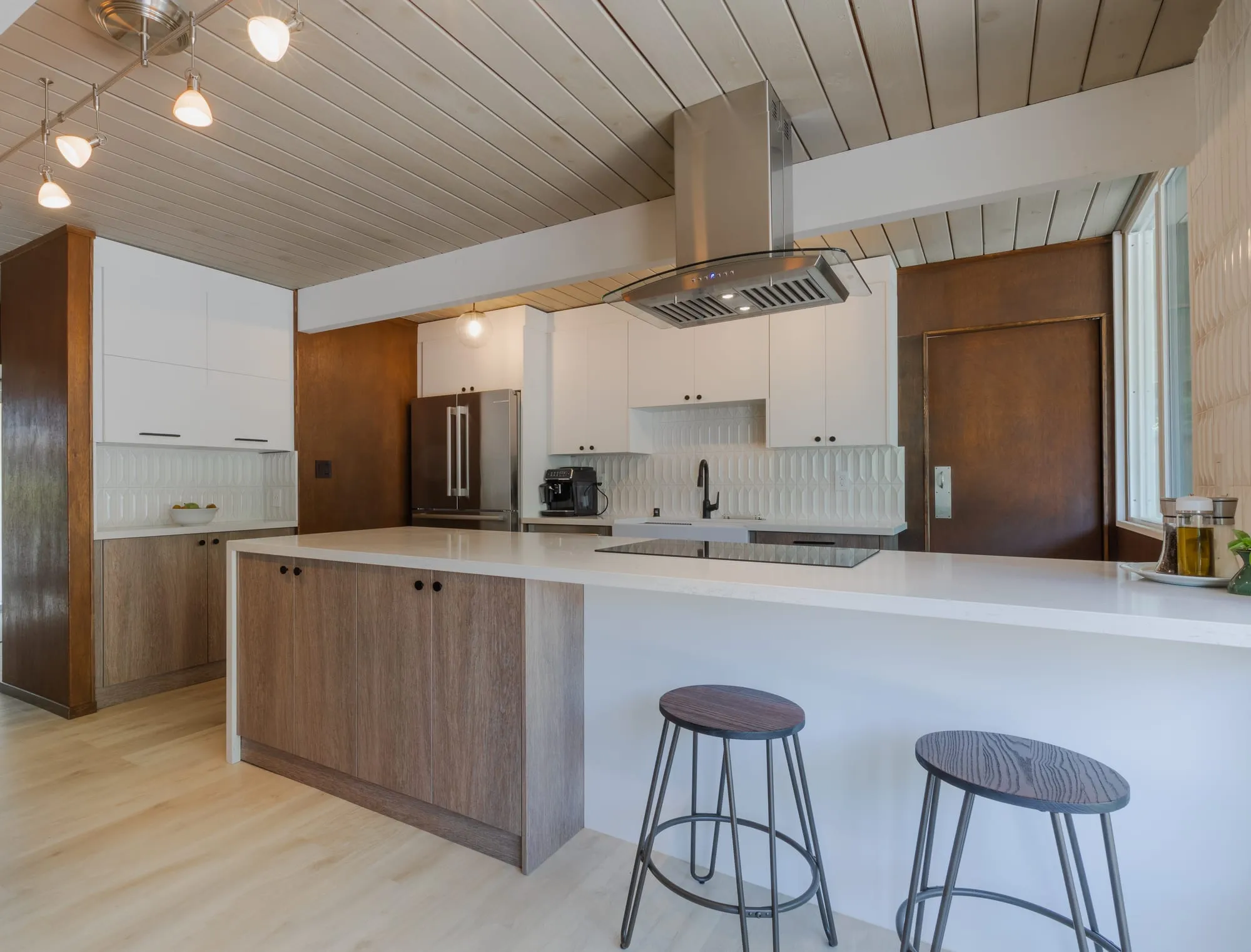 Island and stainless hood seen across the room