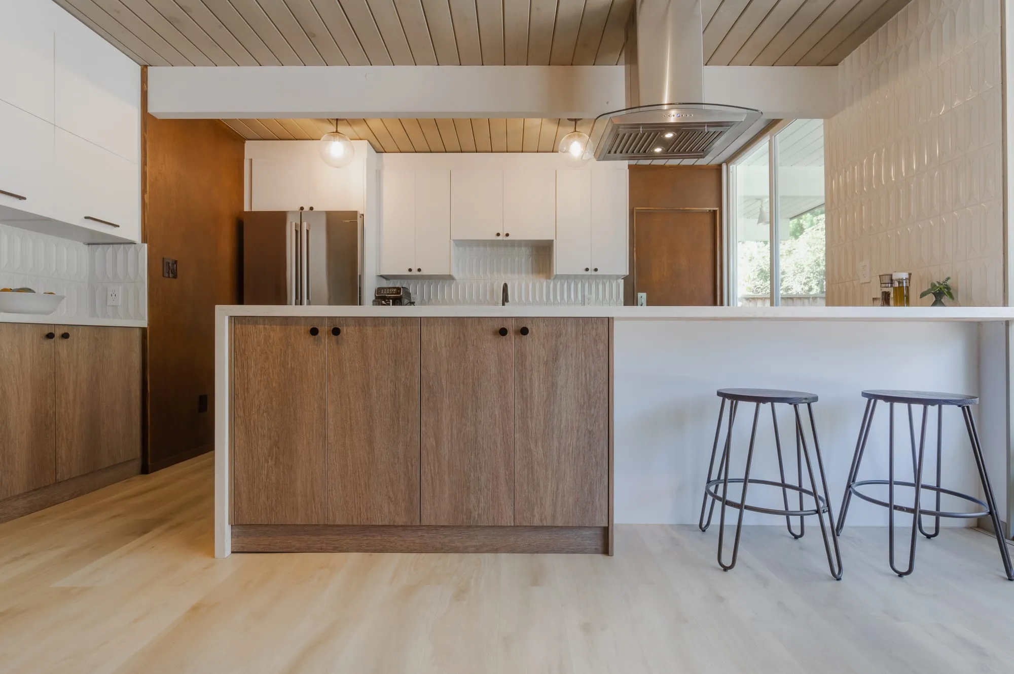 Island below the plank ceiling and track lighting