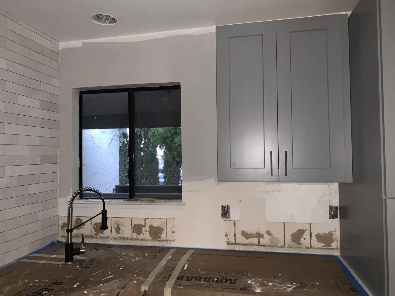 The kitchen during the build, cabinetry set in place before counters and appliances