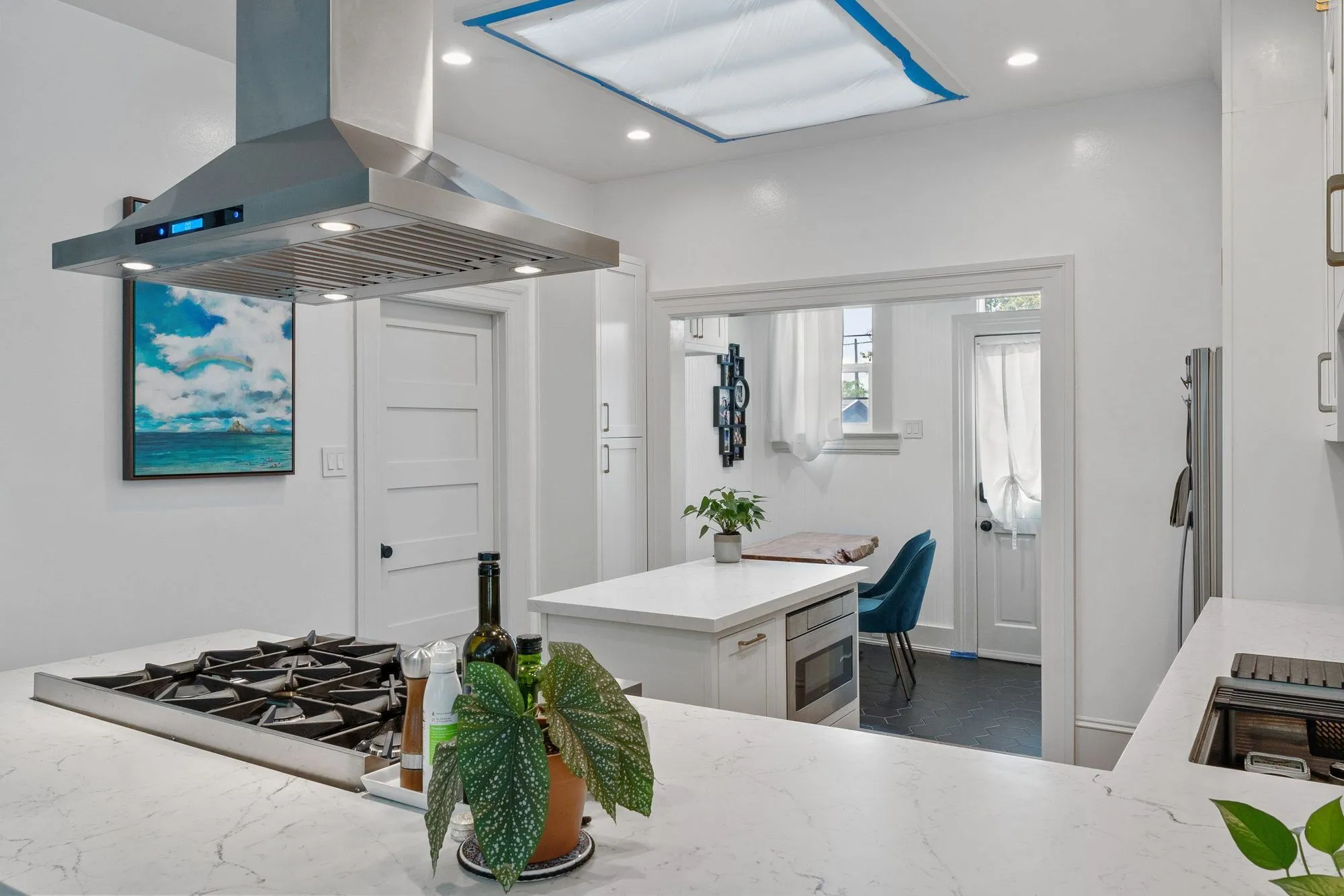 Island seating with upholstered bar stools tucked beneath the quartz overhang