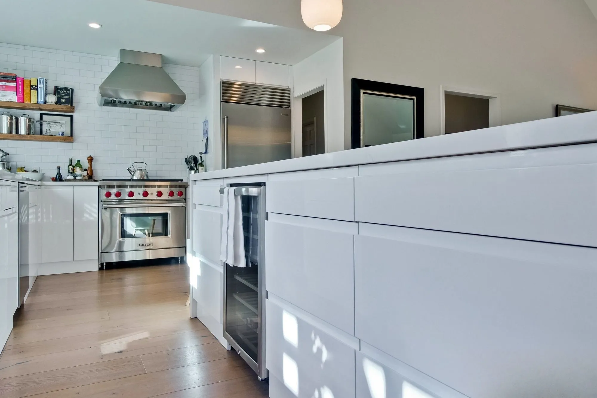 Kitchen island and counter run with a professional stainless range against white subway tile
