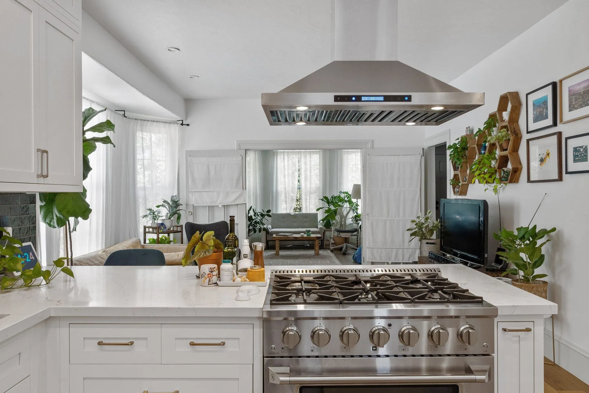 Professional stainless range set against the deep teal tile backsplash