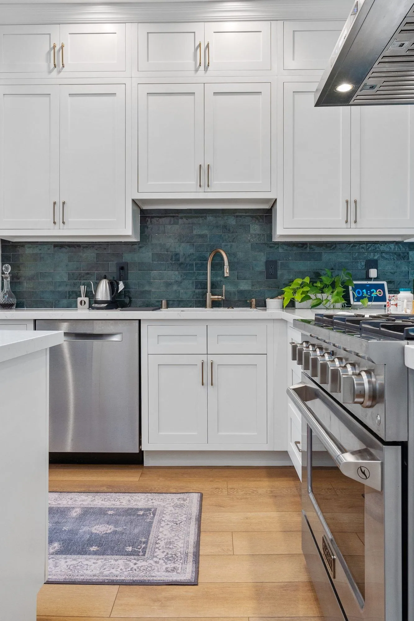 Sink and dishwasher set into the counter run below the teal tile