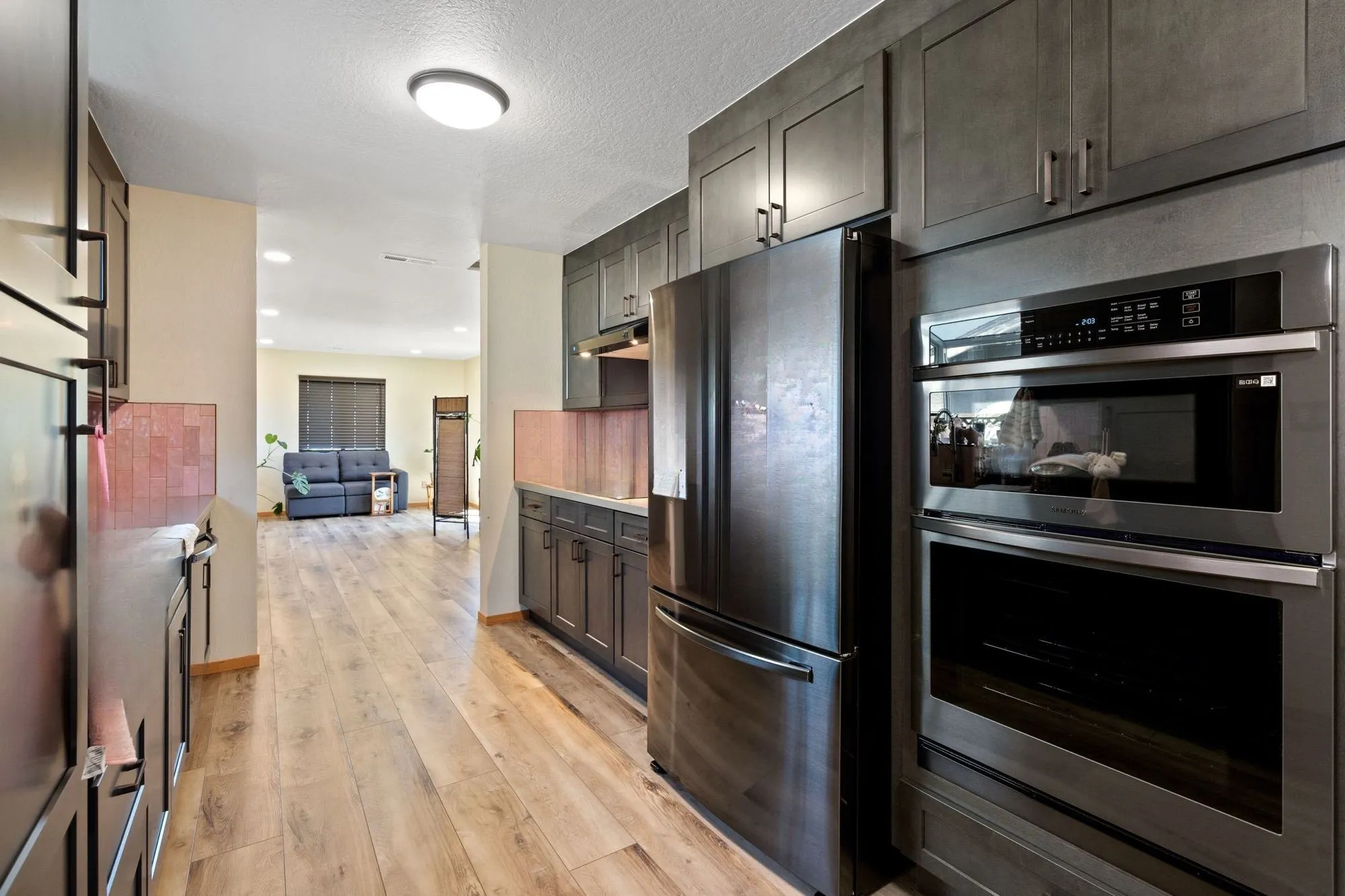 Stacked wall ovens set into dark shaker cabinetry