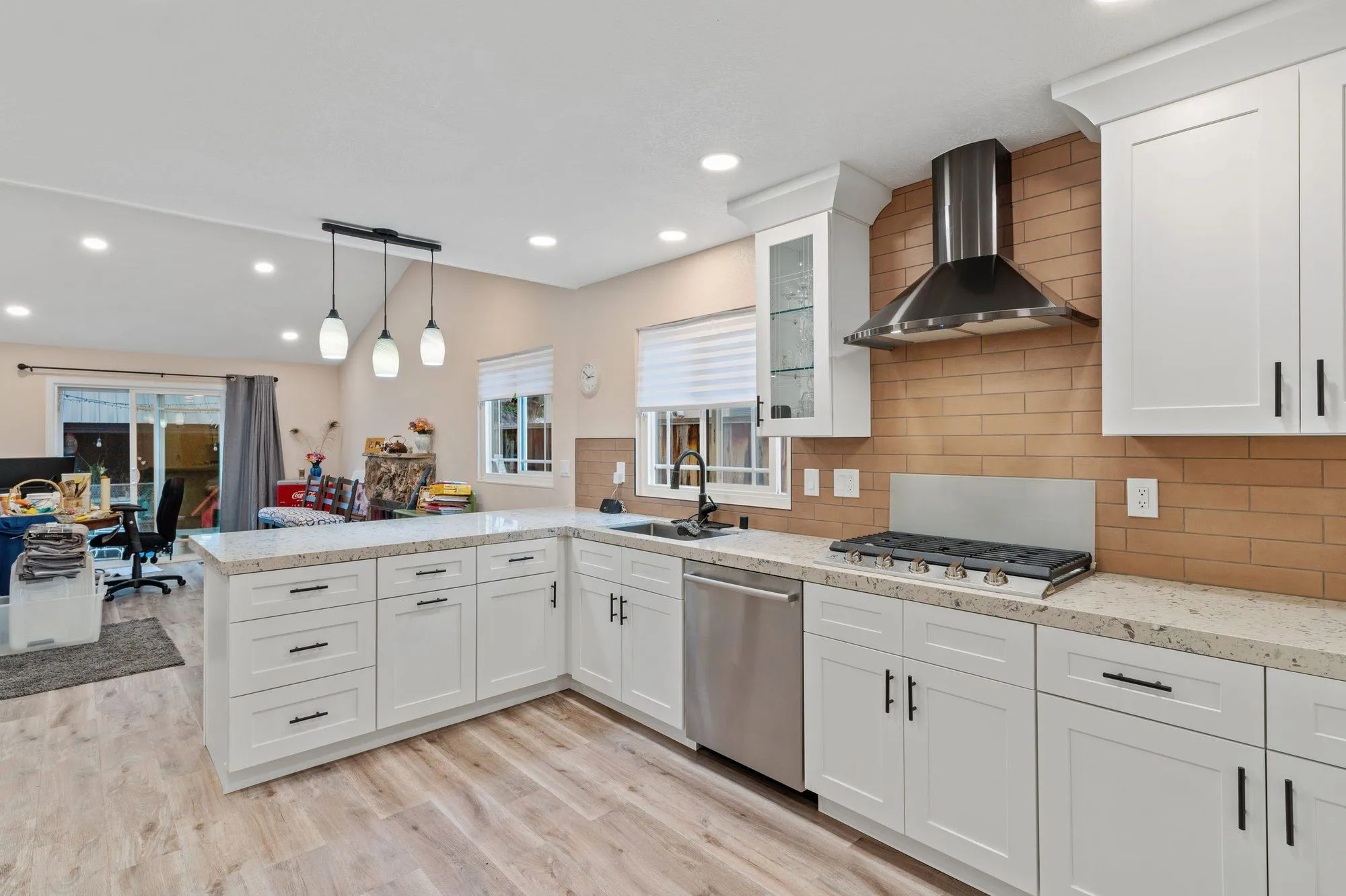 Wide view of the kitchen looking through to the adjoining living space