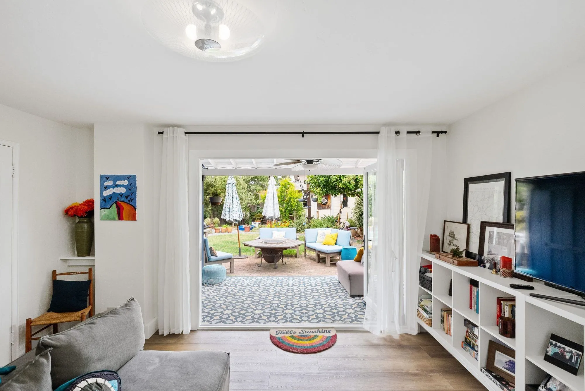 Living room looking straight out through open doors onto the rear patio