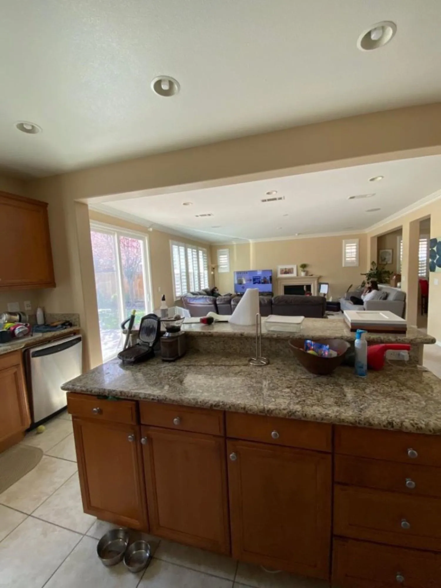 Original granite peninsula before remodel, oak cabinetry and tile flooring