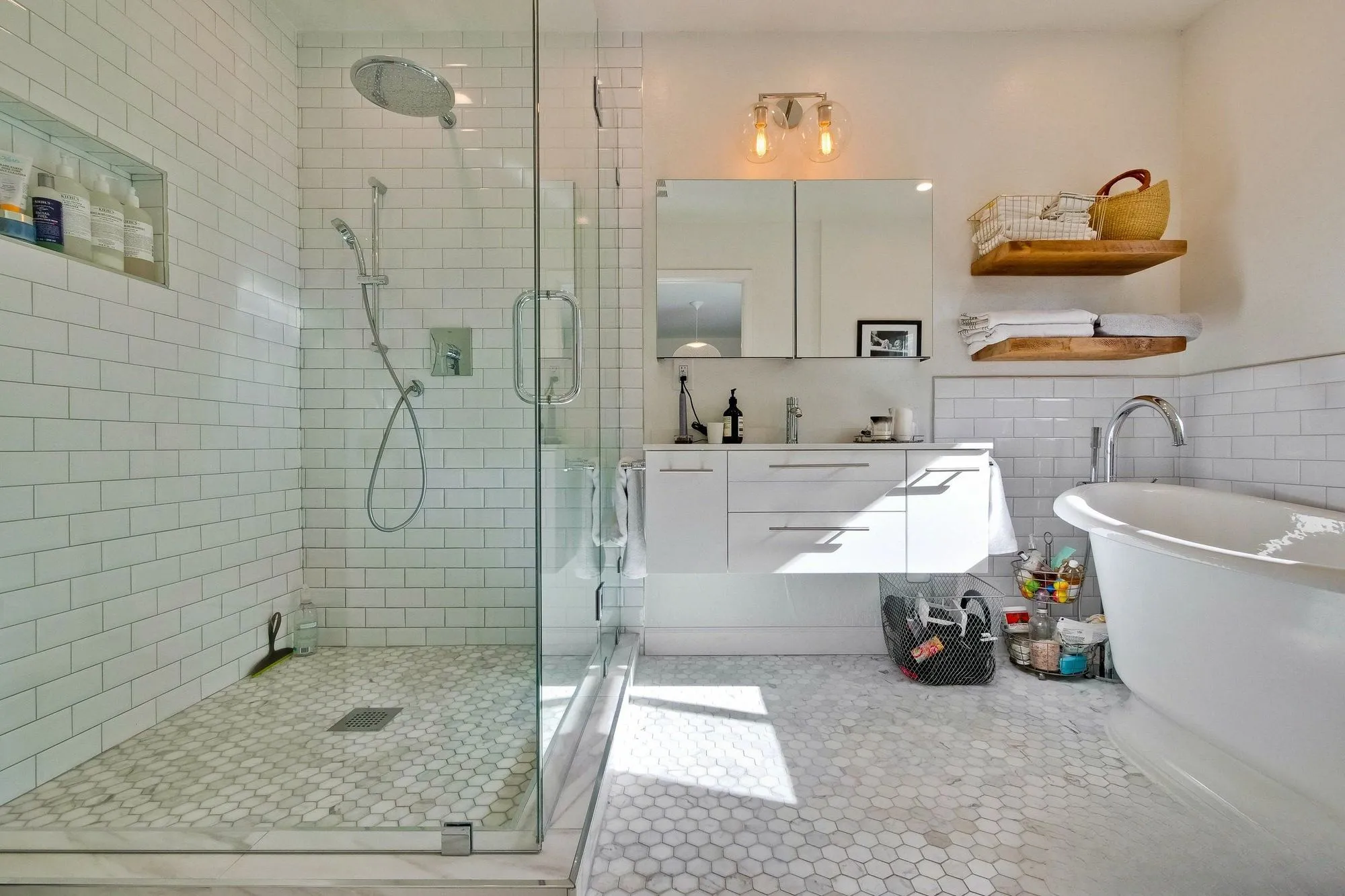 Primary bathroom with a freestanding tub beside a glass-enclosed shower