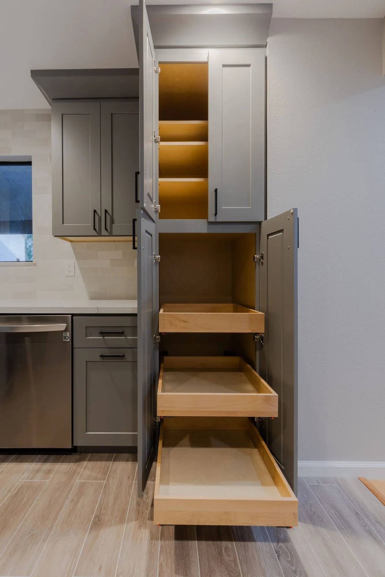 Tall pantry cabinet fitted with full-depth pull-out timber drawers