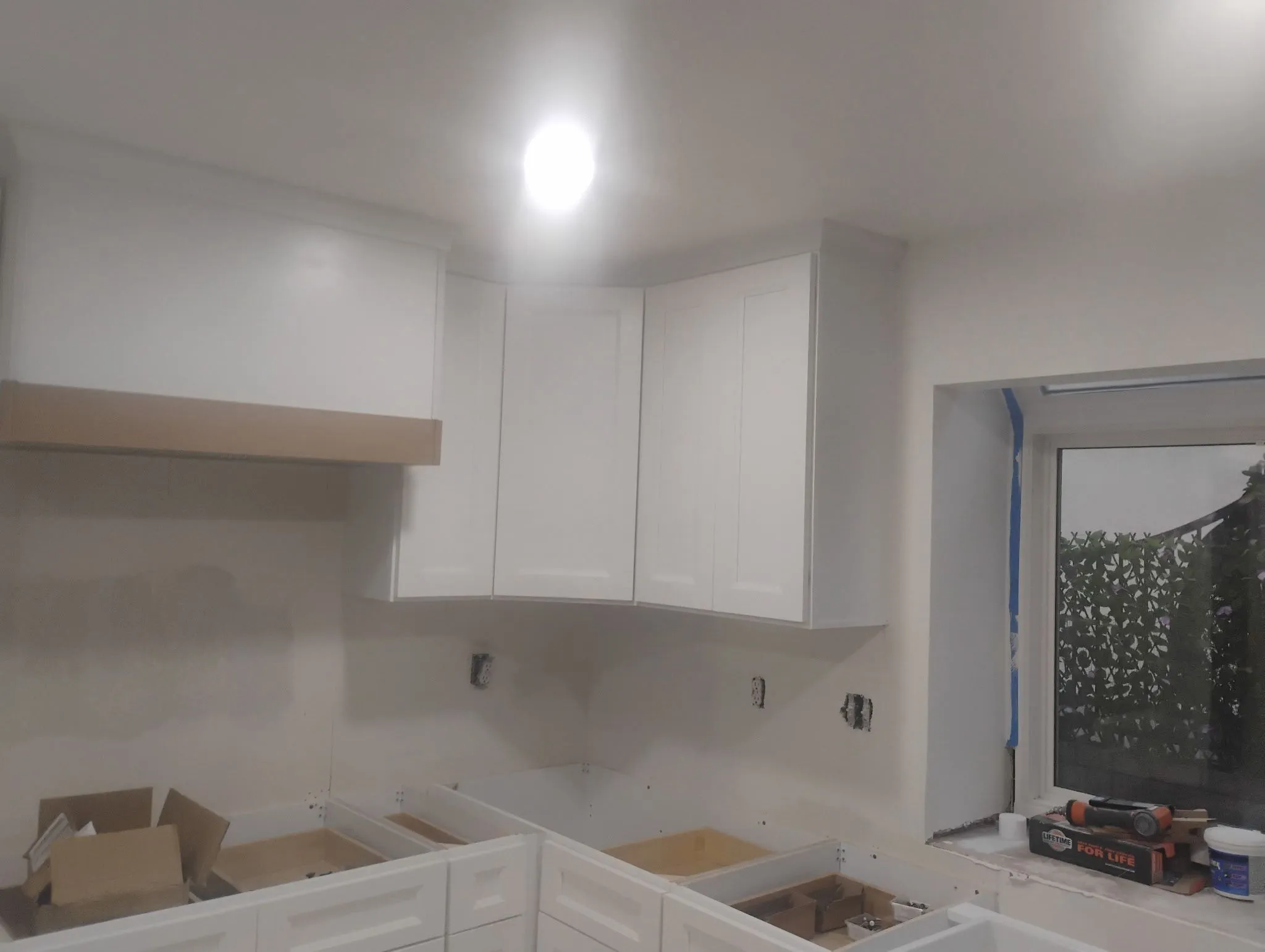 Shell — same range wall before hood cladding, tile, or counters