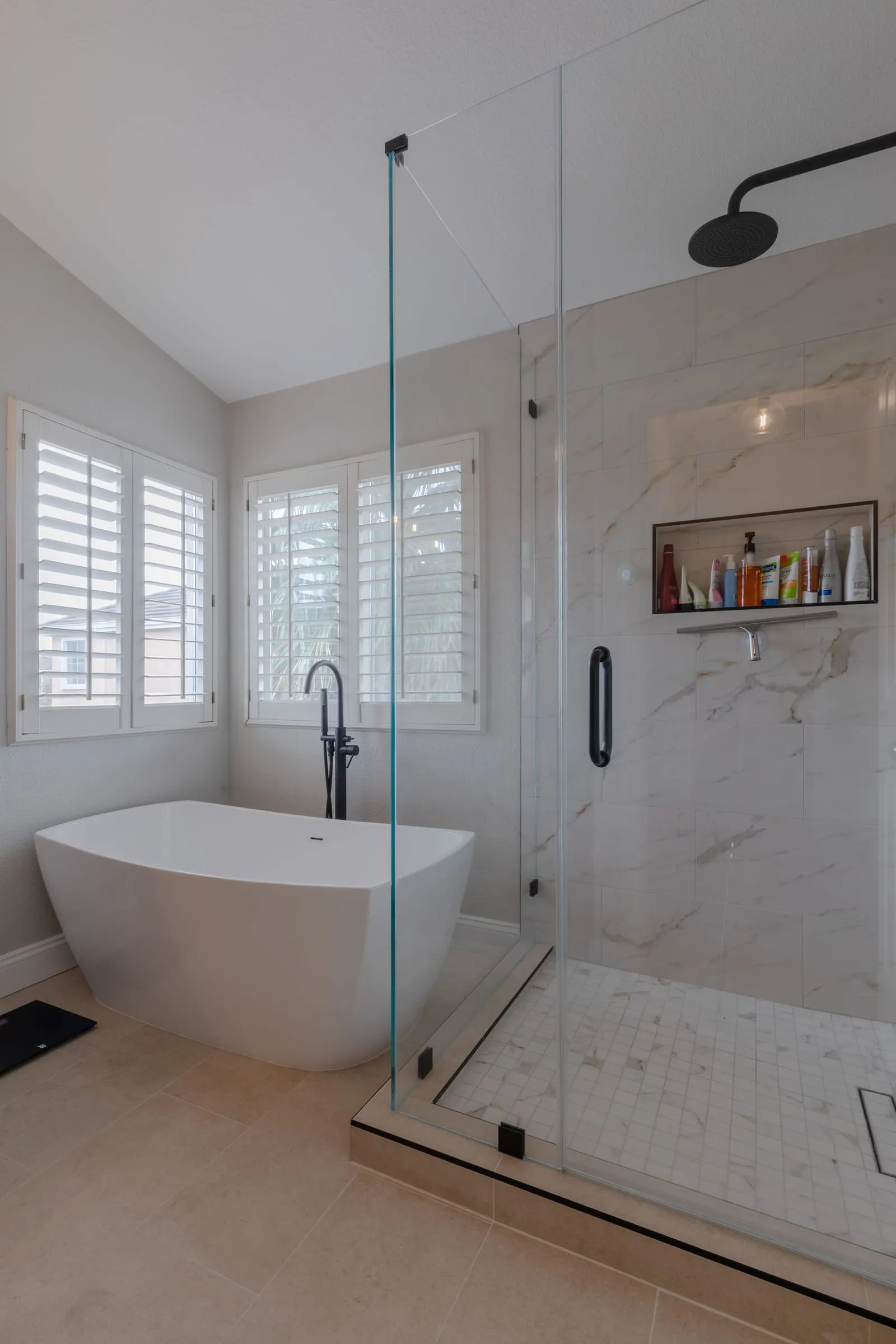 Recessed shower niche in marble-look tile