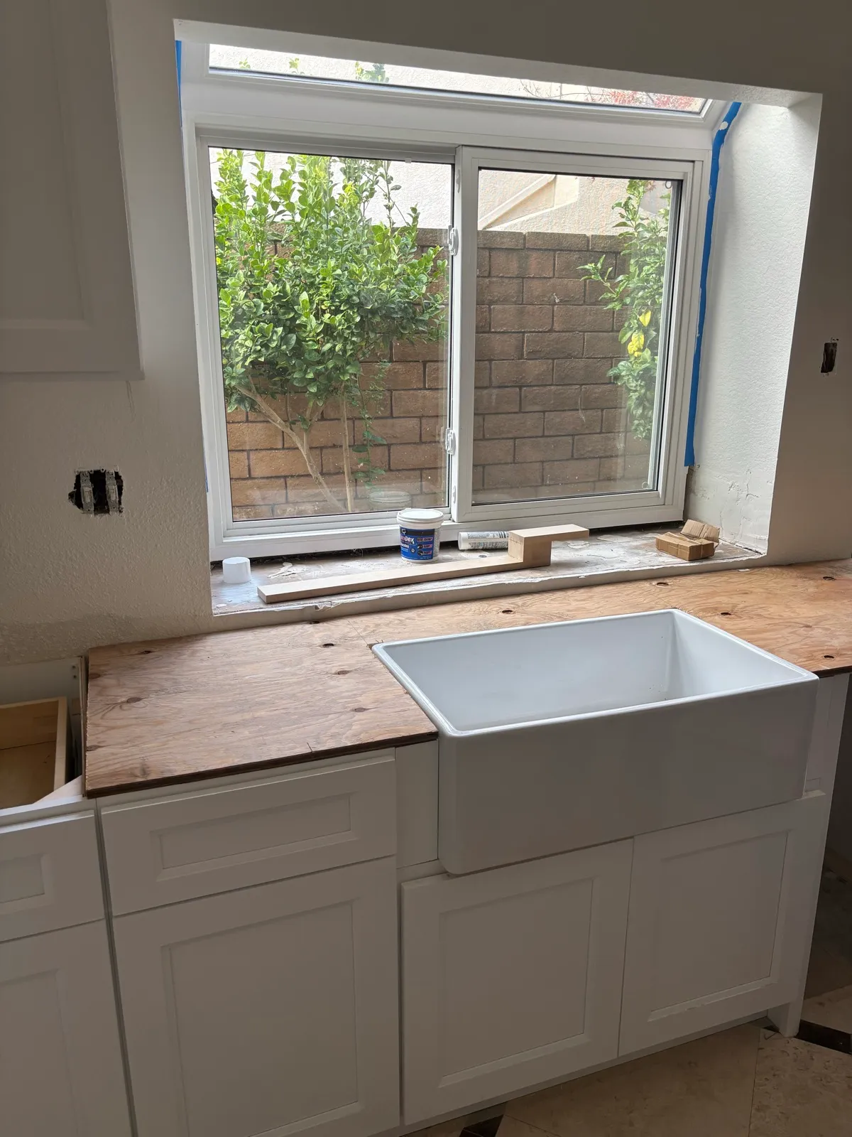 Structural — window frame in, plywood sub-frame for apron sink