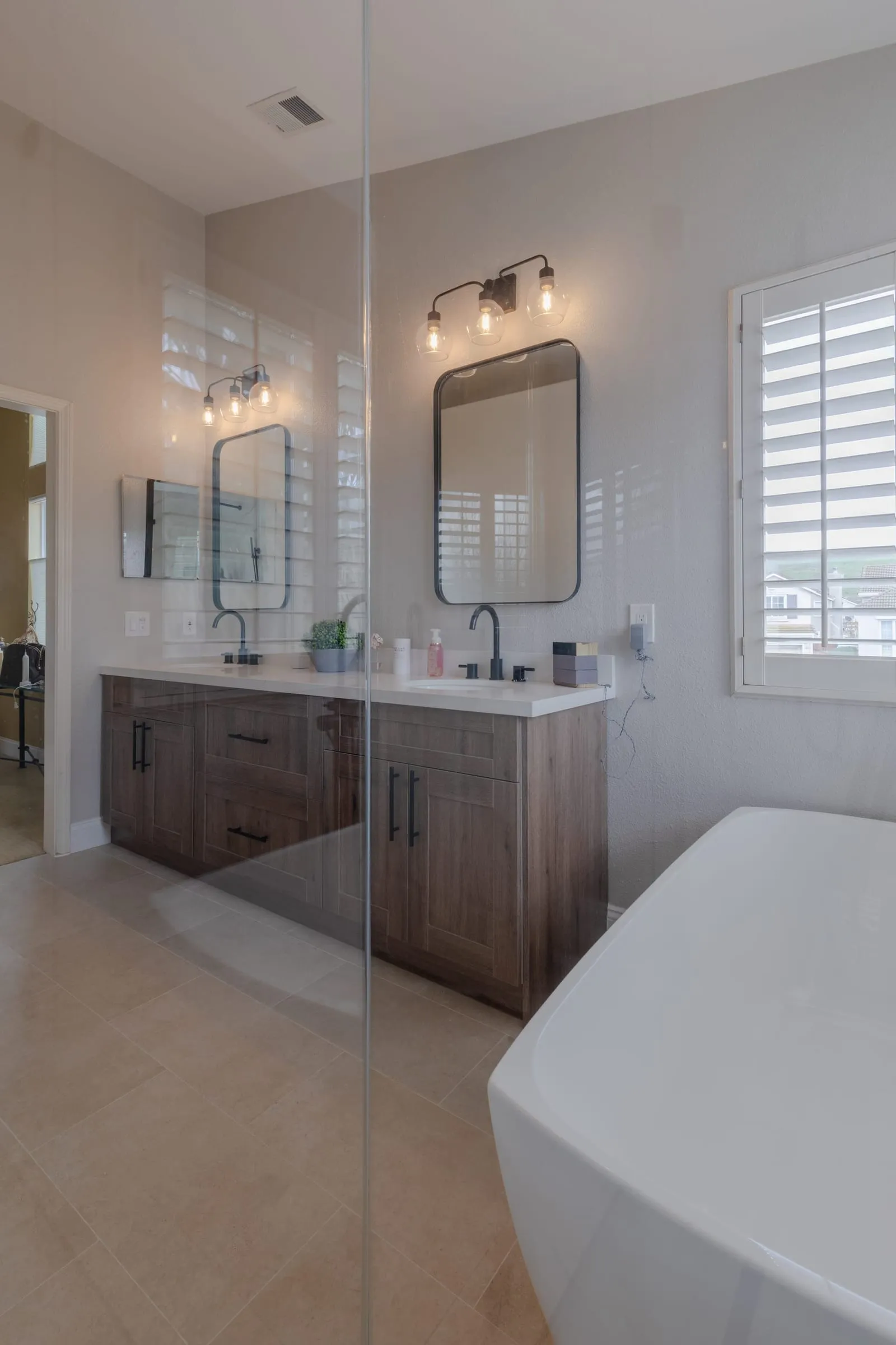 Vanity and tub along the window wall