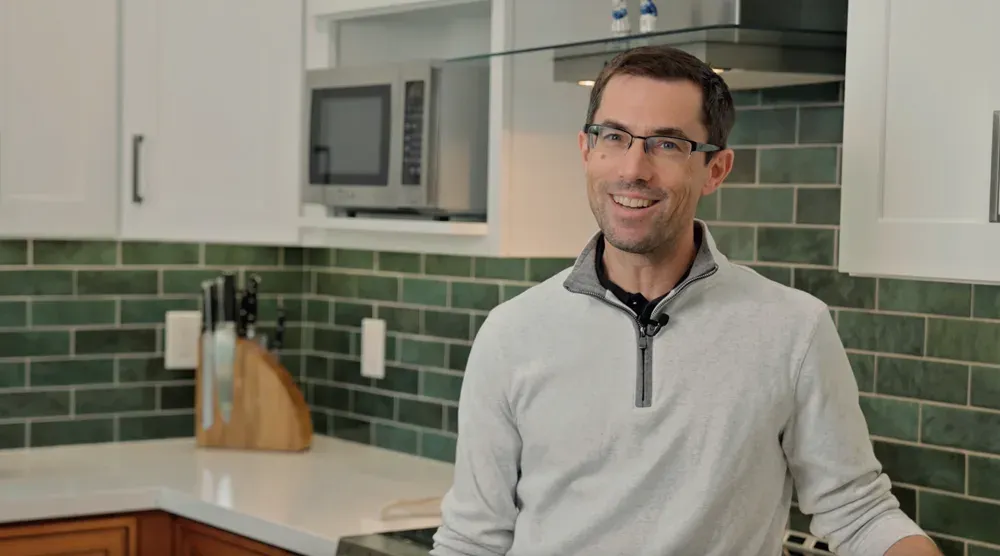 The homeowner — the green-tile kitchen from this remodel