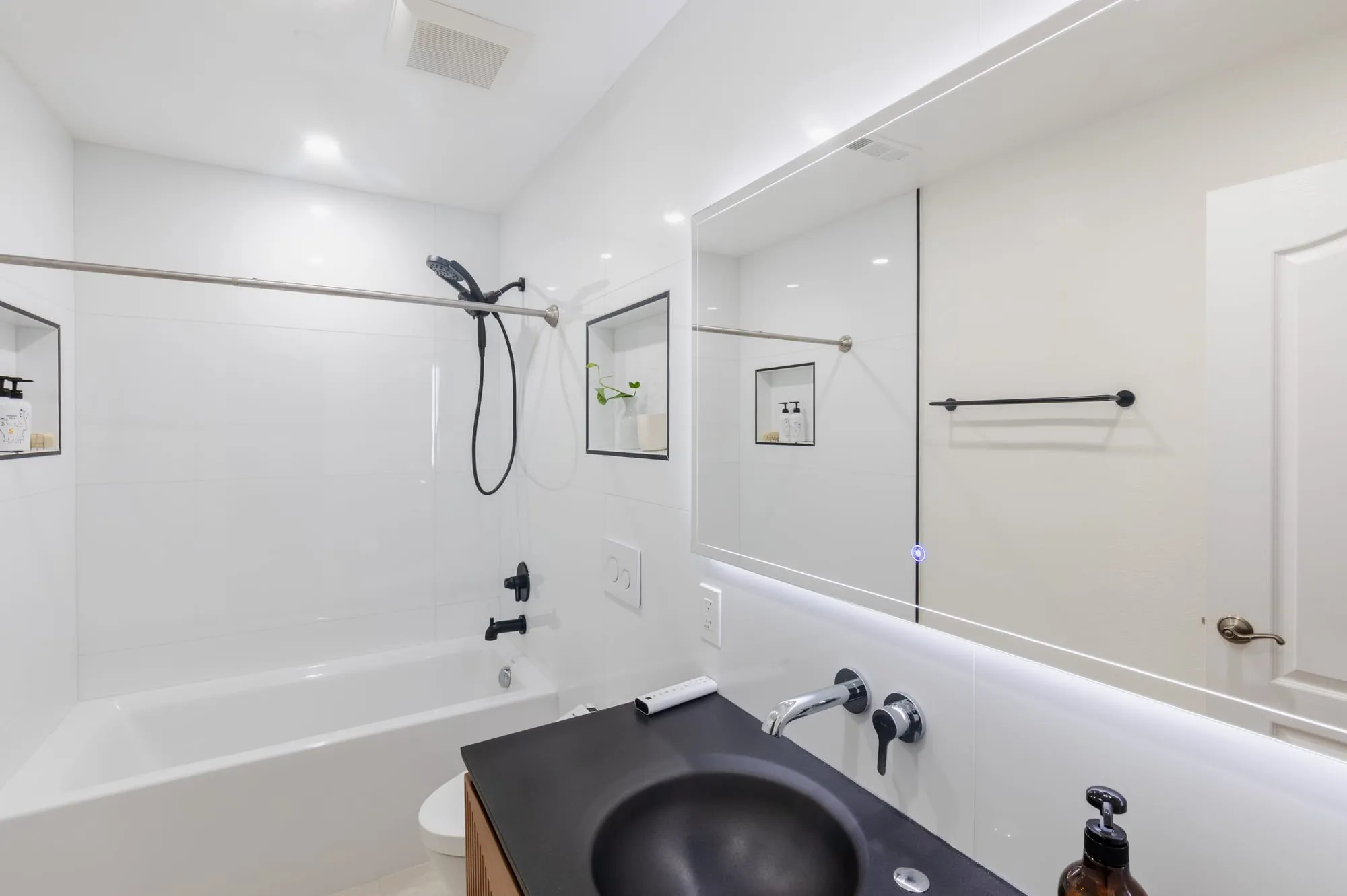 Wide view of the all-white second bathroom