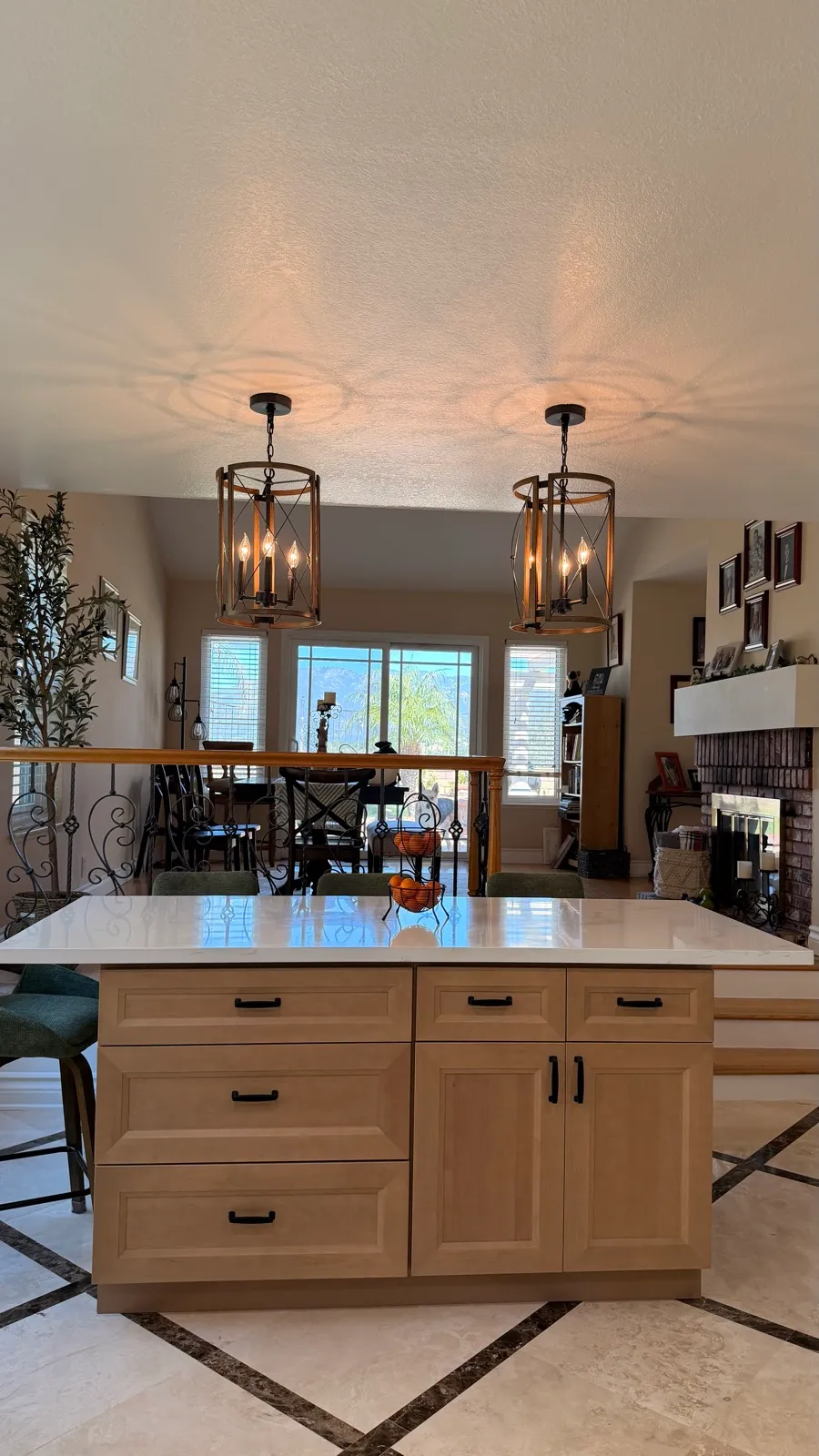 Wood island under lantern pendants